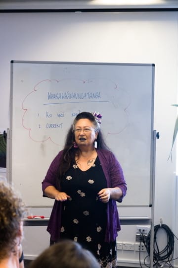 Whaea Elizabeth Kerekere sharing her mātauranga with us, standing in front of a whiteboard.